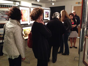 Members of the general public admiring the work of our Photography Beyond the Basics class at a gallery art show